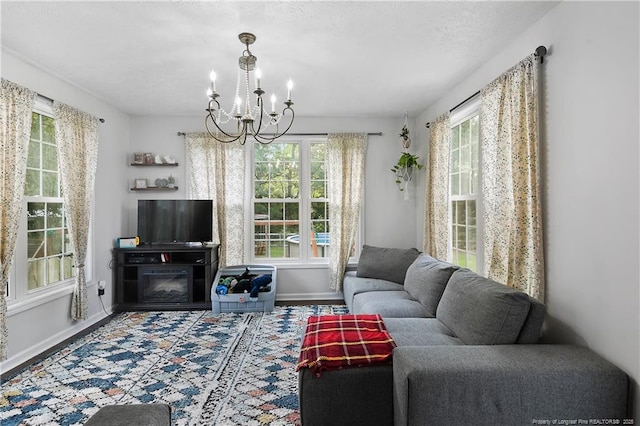 101 Quiet Cv, Raeford, NC 28376 - living area featuring baseboards, a chandelier, and wood finished floors