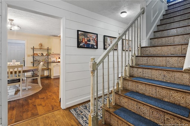 101 Quiet Cv, Raeford, NC 28376 - stairway featuring a textured ceiling and wood-type flooring