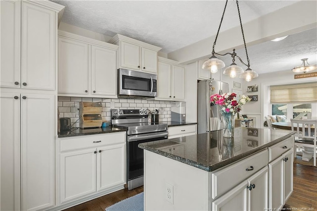 101 Quiet Cv, Raeford, NC 28376 - kitchen with stainless steel appliances, a textured ceiling, decorative backsplash, white cabinets, and dark wood-style floors
