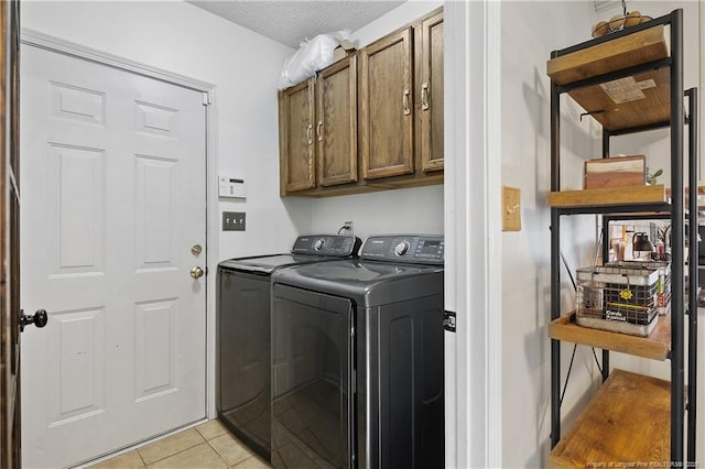101 Quiet Cv, Raeford, NC 28376 - laundry room with washing machine and clothes dryer, cabinet space, light tile patterned flooring, and a textured ceiling