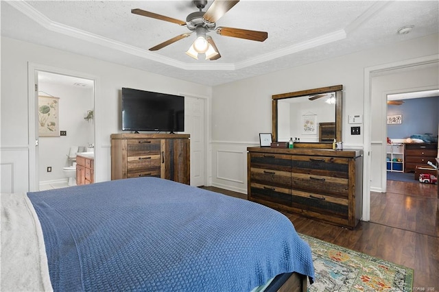 101 Quiet Cv, Raeford, NC 28376 - bedroom with a raised ceiling, wood finished floors, a textured ceiling, crown molding, and a wainscoted wall