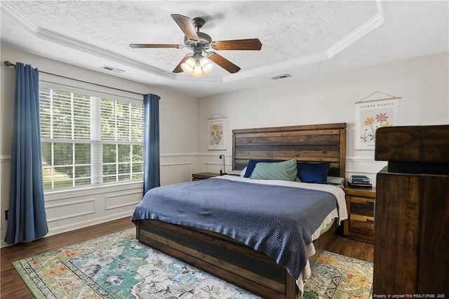 101 Quiet Cv, Raeford, NC 28376 - bedroom with a textured ceiling, a tray ceiling, wood finished floors, crown molding, and a ceiling fan