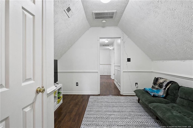 101 Quiet Cv, Raeford, NC 28376 - additional living space featuring a textured ceiling, wood finished floors, vaulted ceiling, and baseboards