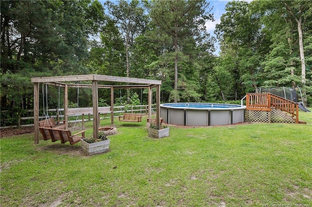 101 Quiet Cv, Raeford, NC 28376 - view of green lawn featuring a wooden deck, a garden, and an outdoor pool