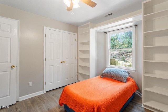 2010 Quaker Lndg Unit 102, Raleigh, NC 27603 - bedroom with wood finished floors, baseboards, a ceiling fan, and a closet