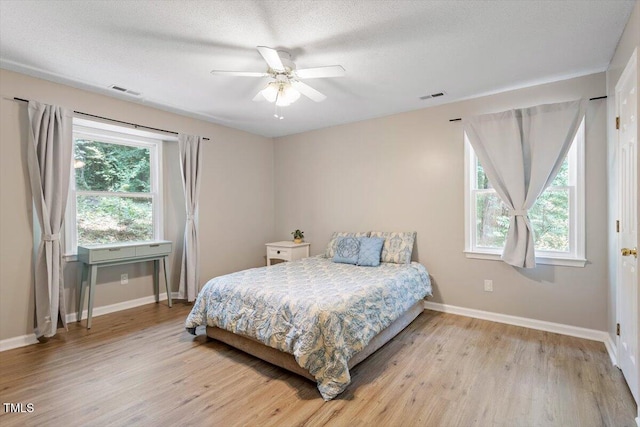 2010 Quaker Lndg Unit 102, Raleigh, NC 27603 - bedroom with baseboards, multiple windows, and light wood-style floors