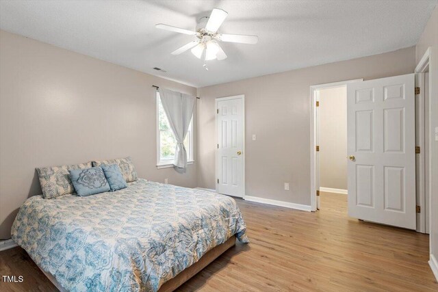 2010 Quaker Lndg Unit 102, Raleigh, NC 27603 - bedroom with light wood-style floors, baseboards, and a ceiling fan