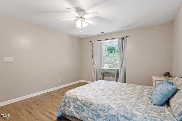 2010 Quaker Lndg Unit 102, Raleigh, NC 27603 - bedroom featuring wood finished floors, baseboards, and ceiling fan