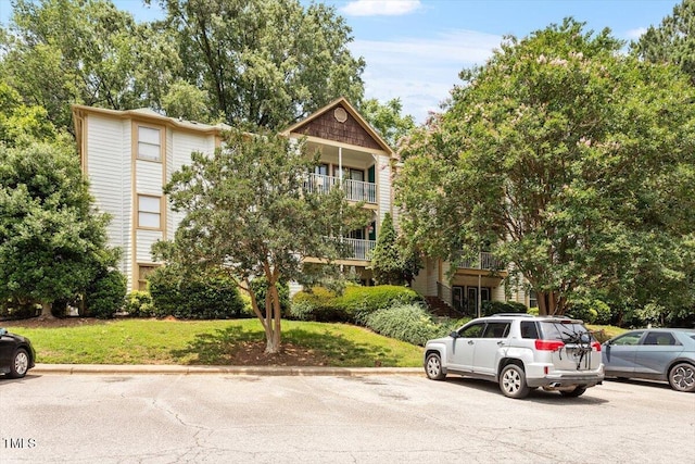 2010 Quaker Lndg Unit 102, Raleigh, NC 27603 - view of front of property with uncovered parking and a front lawn
