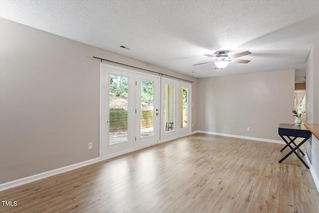 2010 Quaker Lndg Unit 102, Raleigh, NC 27603 - spare room with light wood finished floors, a textured ceiling, baseboards, and a ceiling fan