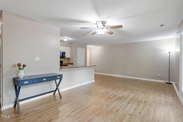 2010 Quaker Lndg Unit 102, Raleigh, NC 27603 - living room with ceiling fan, light wood-style flooring, baseboards, and a textured ceiling