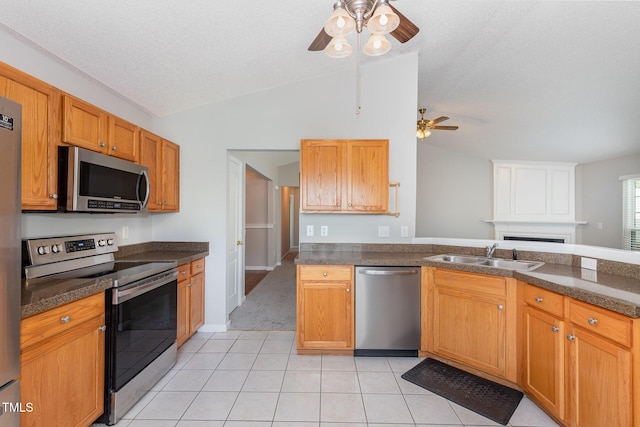 503 Kinship Ln, Apex, NC 27502 - kitchen with appliances with stainless steel finishes, a sink, ceiling fan, lofted ceiling, and light tile patterned floors