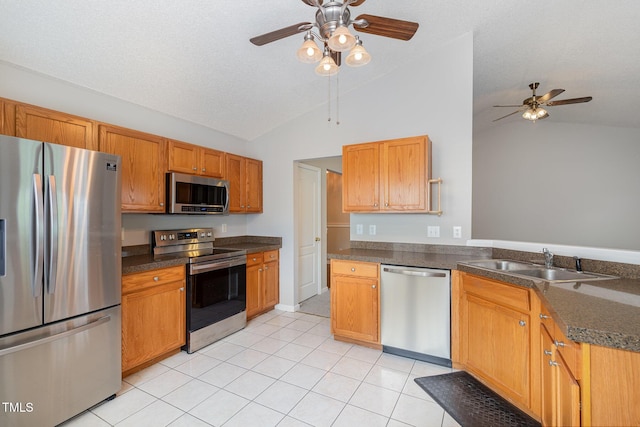 503 Kinship Ln, Apex, NC 27502 - kitchen with stainless steel appliances, lofted ceiling, ceiling fan, light tile patterned floors, and a sink