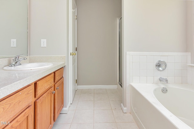 503 Kinship Ln, Apex, NC 27502 - full bath featuring tile patterned flooring, vanity, a garden tub, a shower stall, and baseboards