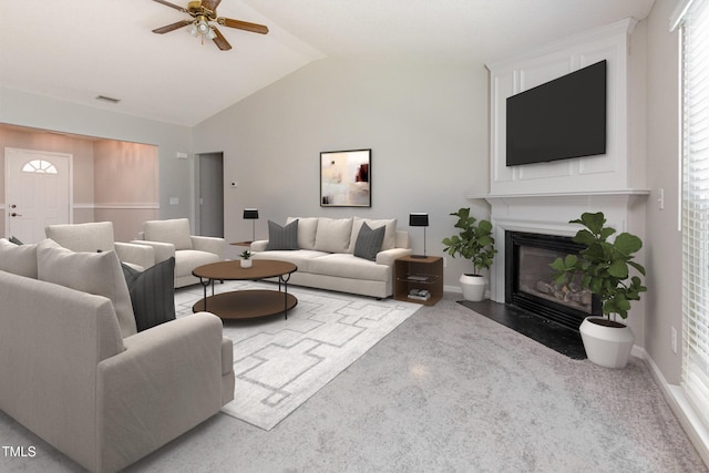503 Kinship Ln, Apex, NC 27502 - carpeted living room featuring vaulted ceiling, a fireplace with flush hearth, ceiling fan, and baseboards