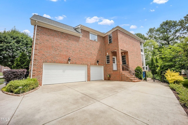 12140 Pawleys Mill Cir, Raleigh, NC 27614 - back of house featuring brick siding, concrete driveway, and a garage
