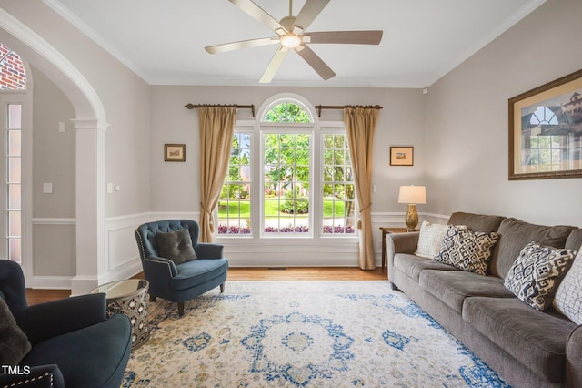 12140 Pawleys Mill Cir, Raleigh, NC 27614 - living area featuring arched walkways, ceiling fan, wainscoting, wood finished floors, and crown molding