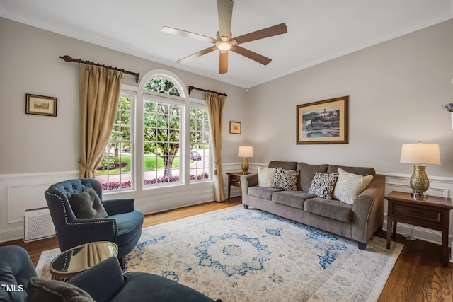 12140 Pawleys Mill Cir, Raleigh, NC 27614 - living area with ceiling fan, ornamental molding, wood finished floors, wainscoting, and a decorative wall