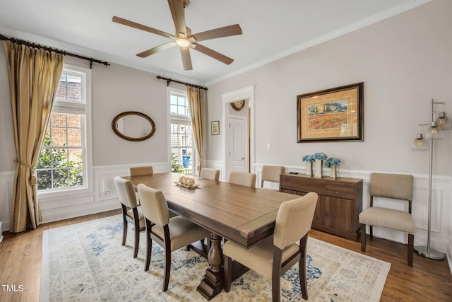 12140 Pawleys Mill Cir, Raleigh, NC 27614 - dining room with wainscoting, ornamental molding, ceiling fan, and light wood-style floors