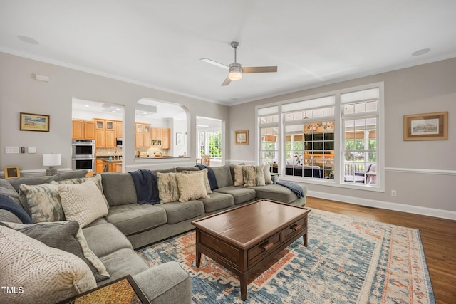 12140 Pawleys Mill Cir, Raleigh, NC 27614 - living room featuring ceiling fan, wood finished floors, crown molding, baseboards, and arched walkways
