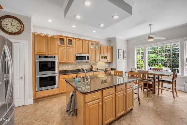 12140 Pawleys Mill Cir, Raleigh, NC 27614 - kitchen with stainless steel appliances, backsplash, light tile patterned floors, a kitchen island with sink, and crown molding