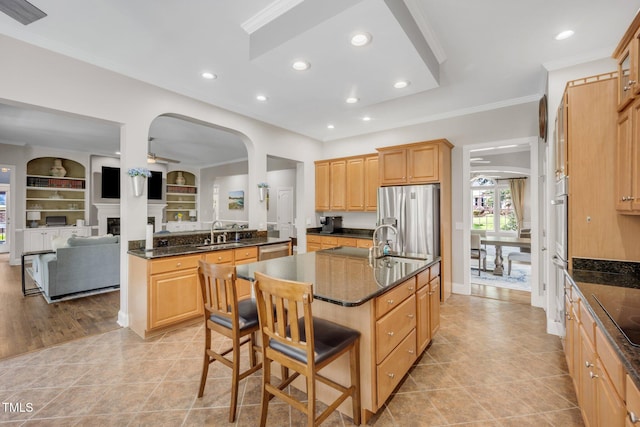 12140 Pawleys Mill Cir, Raleigh, NC 27614 - kitchen featuring stainless steel appliances, a sink, an island with sink, a breakfast bar area, and ornamental molding