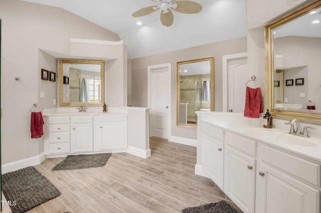 12140 Pawleys Mill Cir, Raleigh, NC 27614 - full bath with vaulted ceiling, a ceiling fan, two vanities, baseboards, and wood finished floors