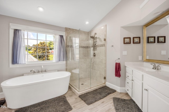 12140 Pawleys Mill Cir, Raleigh, NC 27614 - bathroom with a freestanding tub, a stall shower, vanity, vaulted ceiling, and recessed lighting