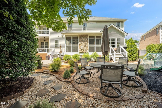12140 Pawleys Mill Cir, Raleigh, NC 27614 - back of property with stairway, a patio area, and outdoor dining space