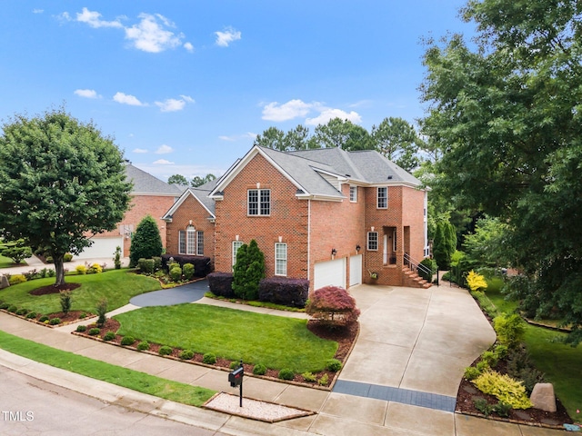 12140 Pawleys Mill Cir, Raleigh, NC 27614 - view of front of house featuring driveway, brick siding, an attached garage, and a front yard