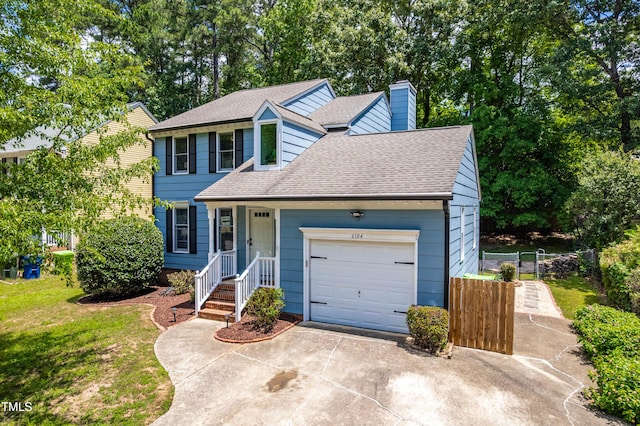 6104 New Market Way, Raleigh, NC 27609 - view of front of house with a chimney, a shingled roof, concrete driveway, and an attached garage