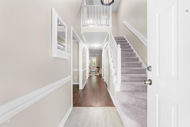 6104 New Market Way, Raleigh, NC 27609 - foyer entrance featuring wood finished floors, stairs, french doors, baseboards, and a towering ceiling
