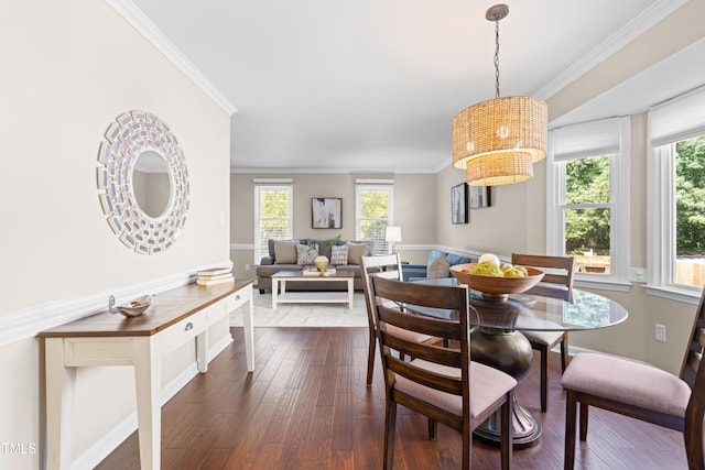 6104 New Market Way, Raleigh, NC 27609 - dining space with a chandelier, ornamental molding, dark wood-style floors, and baseboards