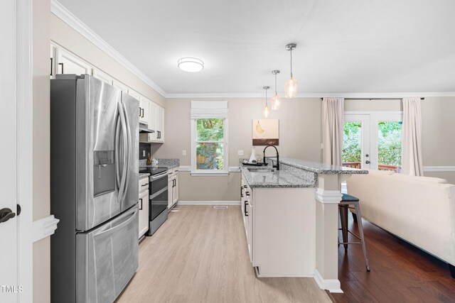 6104 New Market Way, Raleigh, NC 27609 - kitchen featuring stainless steel appliances, a breakfast bar area, light wood-style floors, white cabinetry, and ornamental molding