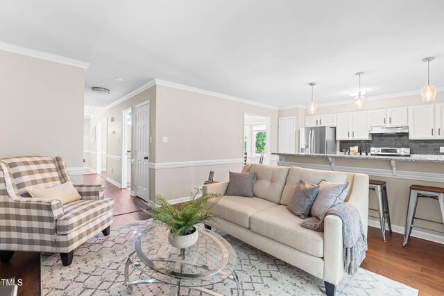 6104 New Market Way, Raleigh, NC 27609 - living room featuring light wood finished floors, crown molding, and baseboards