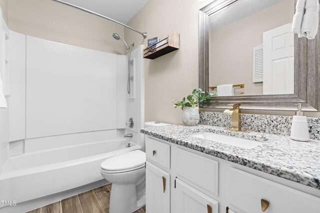6104 New Market Way, Raleigh, NC 27609 - bathroom featuring vanity, toilet, tub / shower combination, and wood finished floors