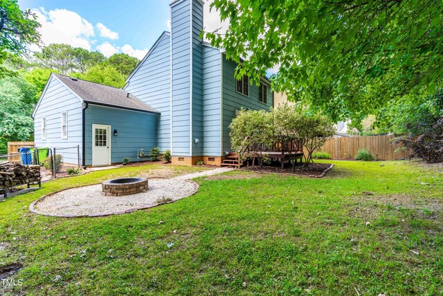 6104 New Market Way, Raleigh, NC 27609 - view of yard featuring an outdoor fire pit and a wooden deck
