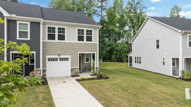 1615 Emory Ridge Way, Wake Forest, NC 27587 - view of front facade with a garage, a front yard, driveway, board and batten siding, and stone siding