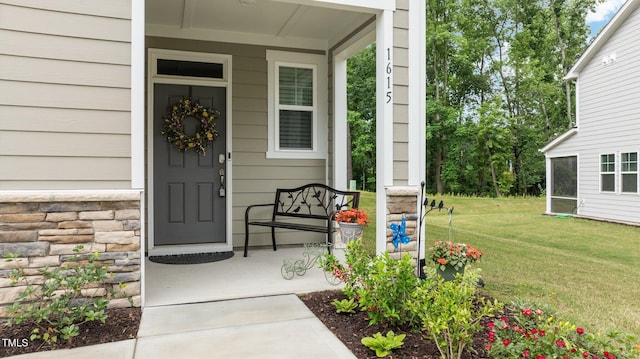 1615 Emory Ridge Way, Wake Forest, NC 27587 - property entrance with covered porch, stone siding, and a yard