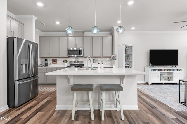 1615 Emory Ridge Way, Wake Forest, NC 27587 - kitchen with appliances with stainless steel finishes, gray cabinets, open floor plan, ornamental molding, and dark wood-type flooring