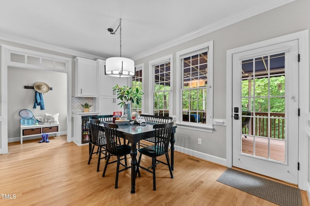 1332 Kinsdale Dr, Raleigh, NC 27615 - dining room featuring ornamental molding, light wood-style floors, baseboards, and a chandelier