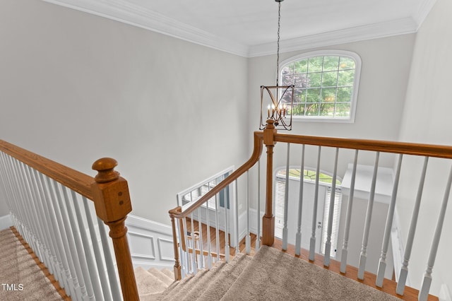 1332 Kinsdale Dr, Raleigh, NC 27615 - stairs with a chandelier, crown molding, and a decorative wall