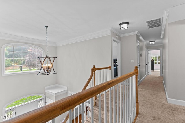 1332 Kinsdale Dr, Raleigh, NC 27615 - corridor with an upstairs landing, light carpet, a chandelier, baseboards, and crown molding