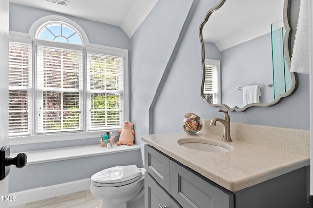 1332 Kinsdale Dr, Raleigh, NC 27615 - bathroom with vanity, toilet, and lofted ceiling