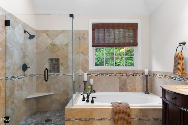 1332 Kinsdale Dr, Raleigh, NC 27615 - full bathroom featuring vanity, a garden tub, a stall shower, and tile walls