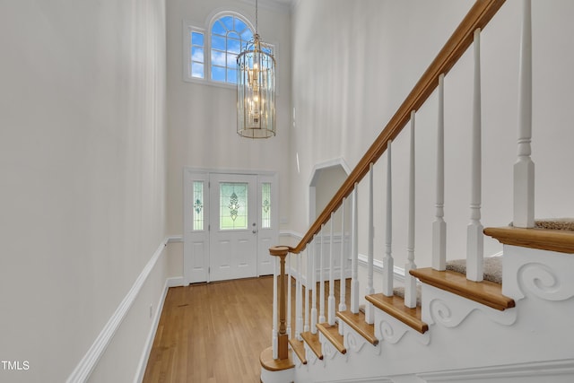 5121 Ten Point Trl, Wake Forest, NC 27587 - entryway with a chandelier, a towering ceiling, stairway, and wood finished floors