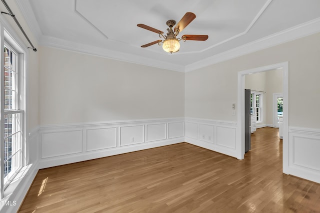 5121 Ten Point Trl, Wake Forest, NC 27587 - unfurnished room featuring light wood-style flooring, a wainscoted wall, a ceiling fan, and ornamental molding