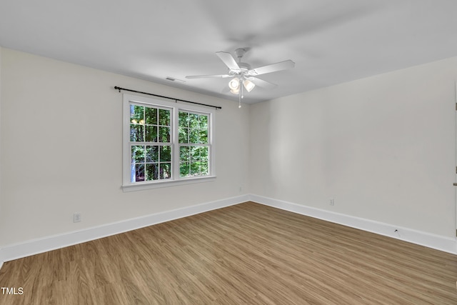 5121 Ten Point Trl, Wake Forest, NC 27587 - unfurnished room with wood finished floors, ceiling fan, and baseboards