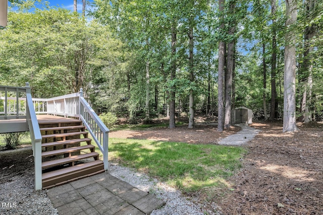 5121 Ten Point Trl, Wake Forest, NC 27587 - view of yard with stairway, a wooden deck, and a wooded view