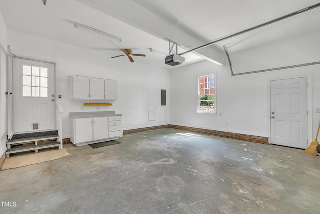 5121 Ten Point Trl, Wake Forest, NC 27587 - garage featuring a garage door opener, electric panel, ceiling fan, and baseboards